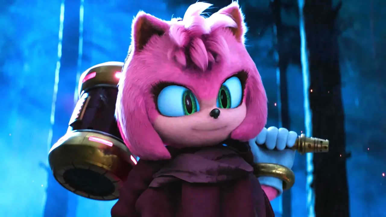Amy sorride mentre tiene in mano il suo martello in una foresta in Sonic the Hedgehog 3 Amy sorride mentre tiene in mano il suo martello in una foresta in Sonic the Hedgehog 3