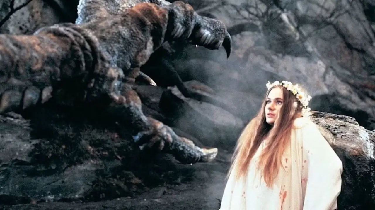 Un grande artiglio di drago che sta per afferrare una donna in Dragonslayer